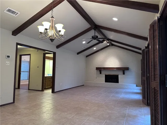 a view of an empty room with a chandelier