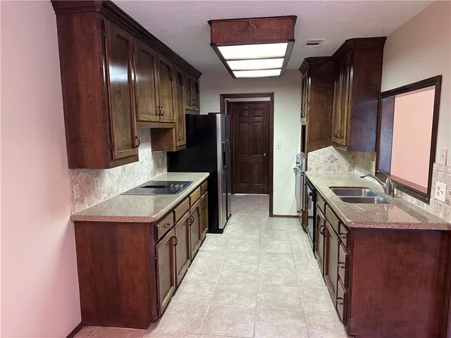 a kitchen with a sink stove and cabinets