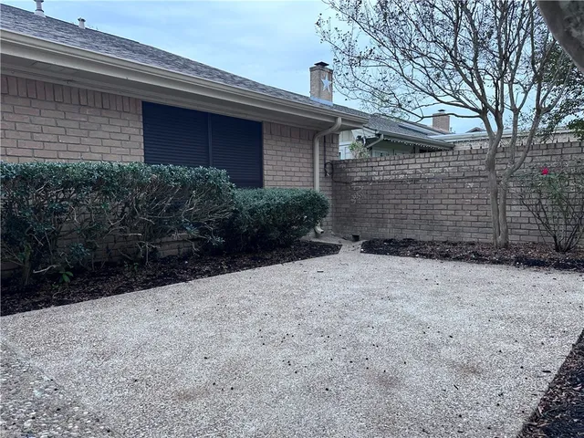 a view of backyard of house with green space