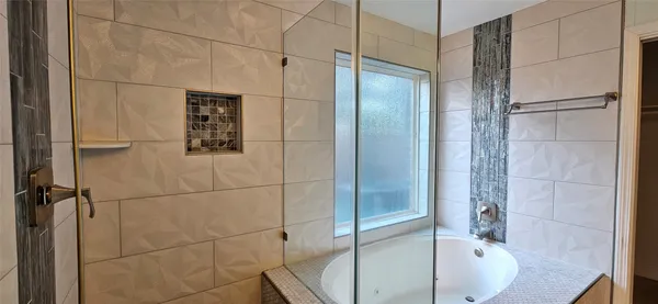 a bathroom with a bathtub and shower