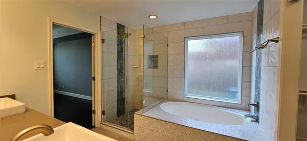 a bathroom with a granite countertop sink mirror and shower
