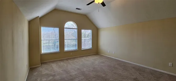 an empty room with windows and entertaining space