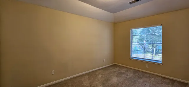a view of a room with blue walls with a window
