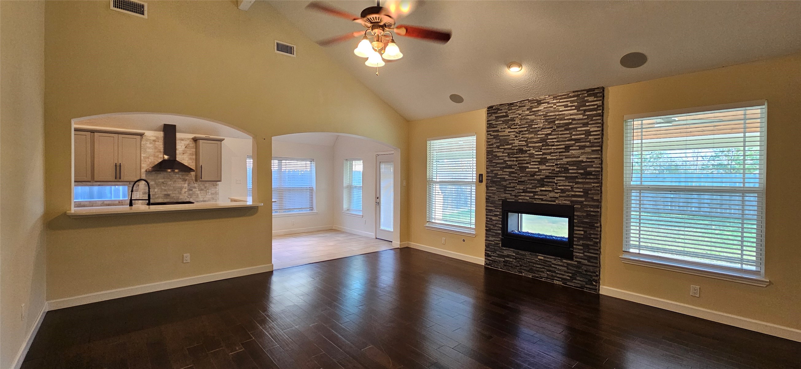 13035 Bainbridge Trail Houston, TX 77065 - Photo 6 of 31 a view of a livingroom with furniture wooden floor a ceiling fan and windows