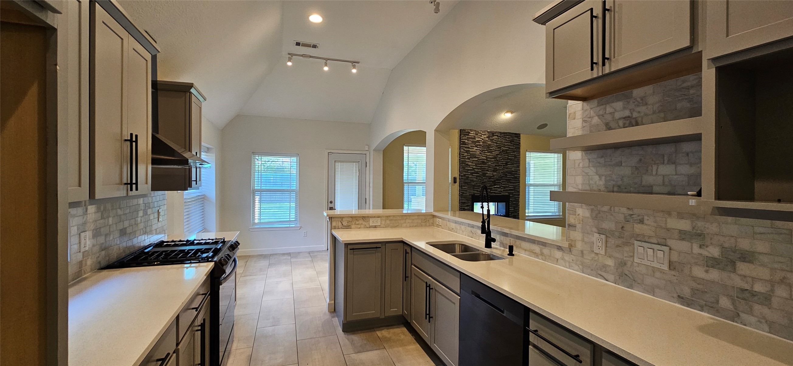 13035 Bainbridge Trail Houston, TX 77065 - Photo 9 of 31 a large kitchen with stainless steel appliances a sink and cabinets