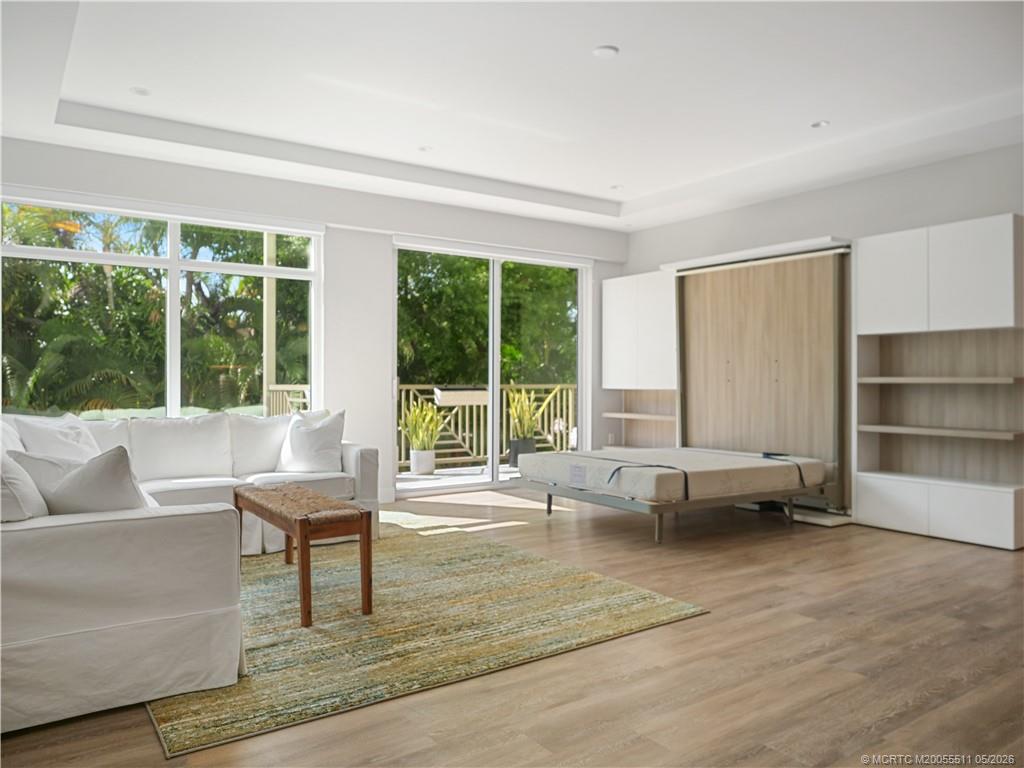 41 Southwest Seminole Street, Unit 208 Stuart, FL 34994 - Photo 16 of 46 a living room with furniture and a large window