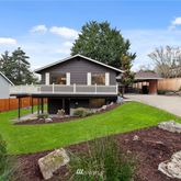 a view of a house with a yard patio and fire pit