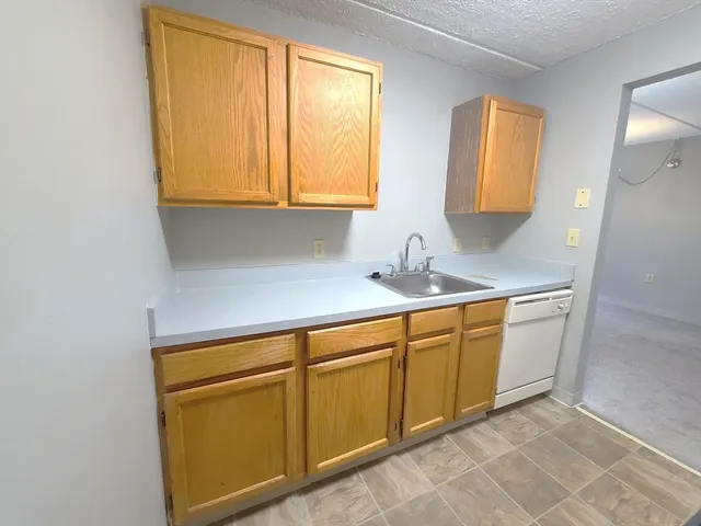 a kitchen with a sink cabinets and a window