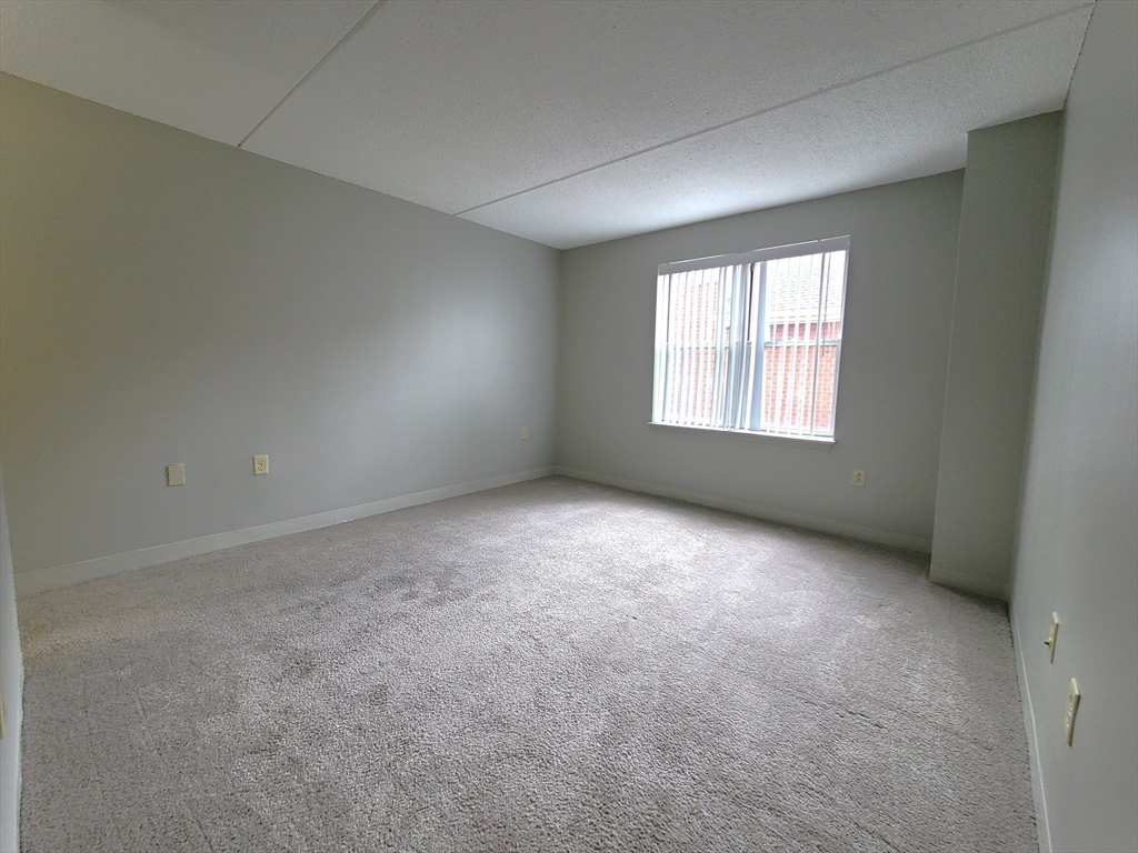 1 South Point Drive, Unit 404 Boston, MA 02125 - Photo 6 of 15 an empty room with a window