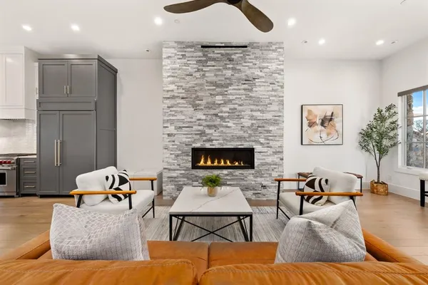 a living room with furniture wooden floor and a fireplace