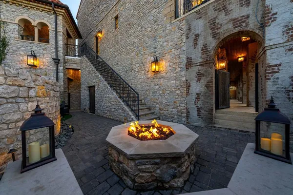 a view of a brick house with a small backyard