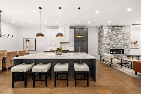 a kitchen with a dining table chairs sink and stove