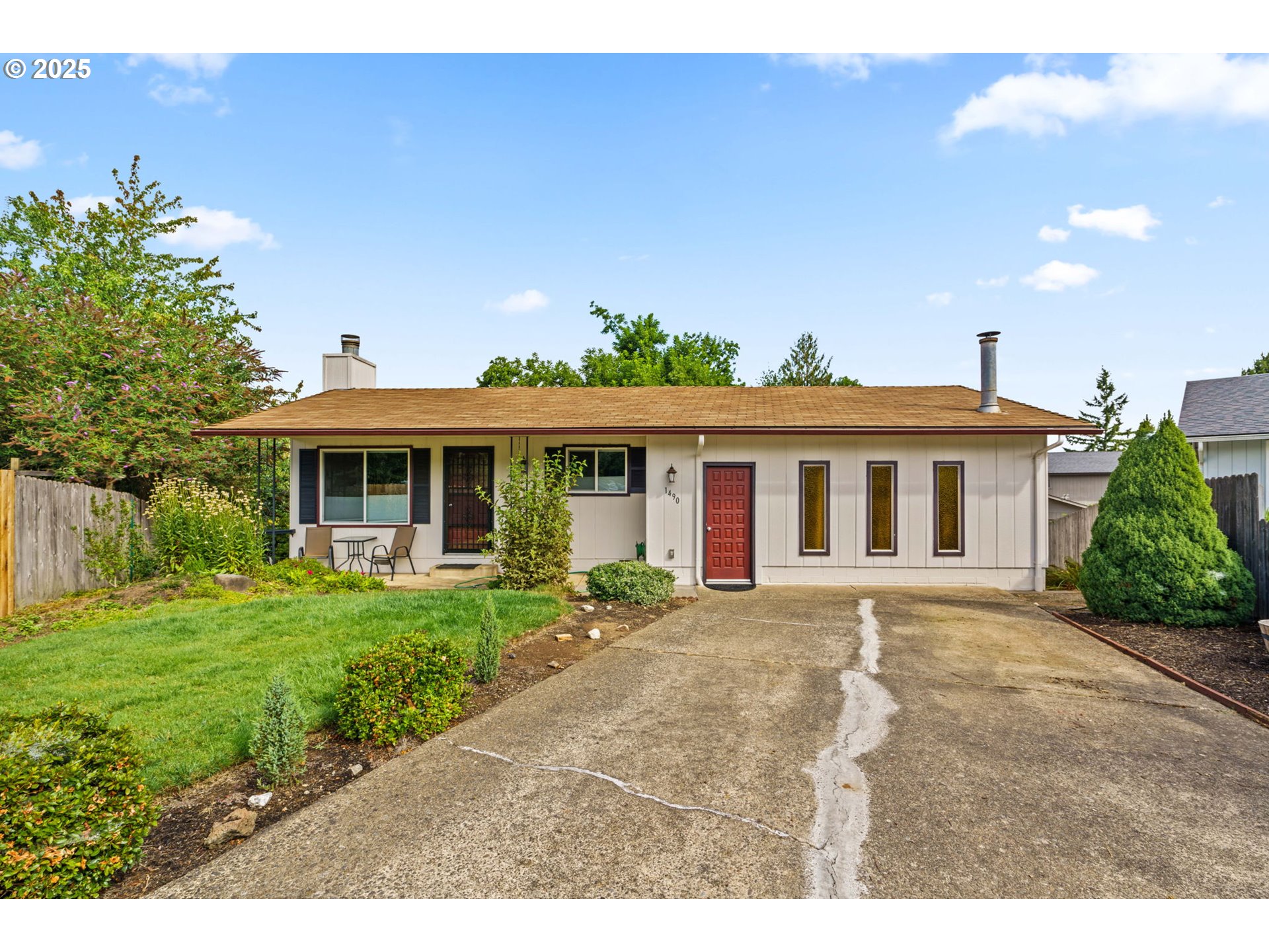 a front view of a house with a garden and yard