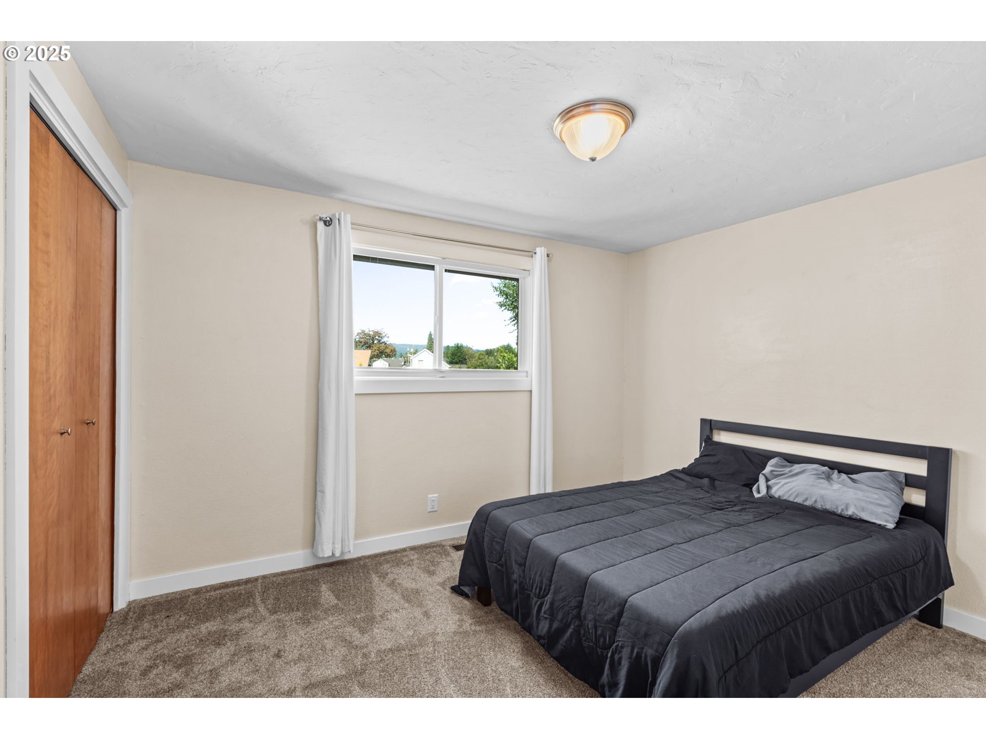 1490 Carobelle Court Cottage Grove, OR 97424 - Photo 17 of 28 a bedroom with a bed and a window