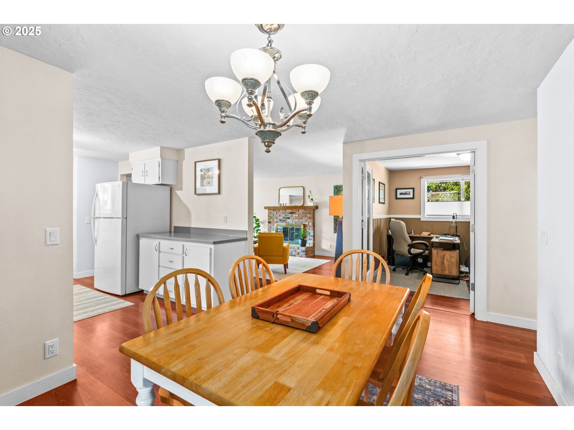 1490 Carobelle Court Cottage Grove, OR 97424 - Photo 6 of 28 a view of a dining room with furniture a chandelier and wooden floor