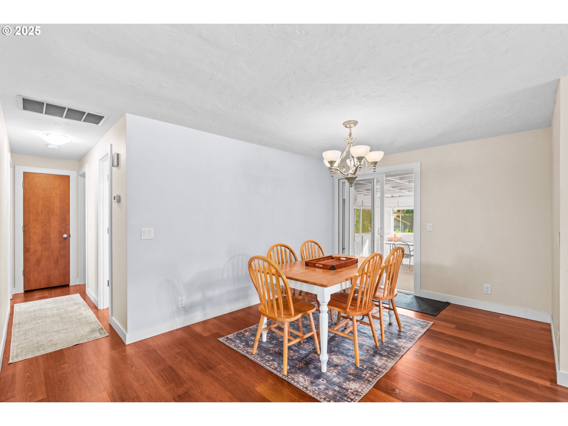 1490 Carobelle Court Cottage Grove, OR 97424 - Photo 7 of 28 a dining room with furniture a chandelier and wooden floor