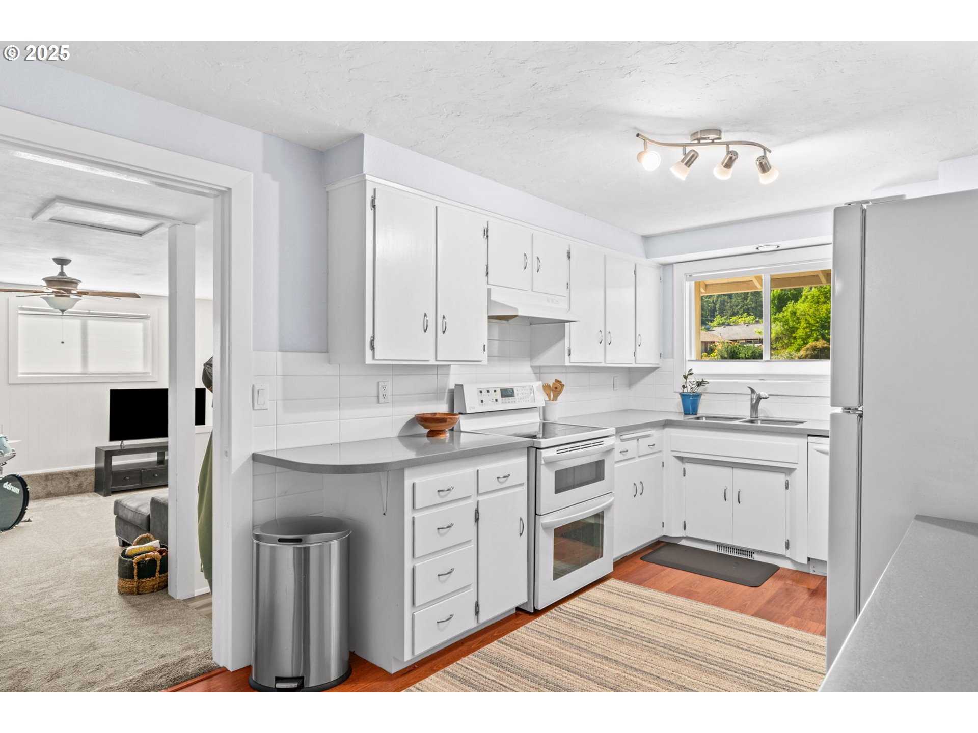 1490 Carobelle Court Cottage Grove, OR 97424 - Photo 9 of 28 a kitchen with a sink cabinets and window