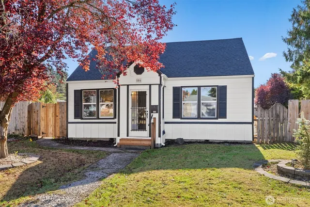 a front view of a house with a garden
