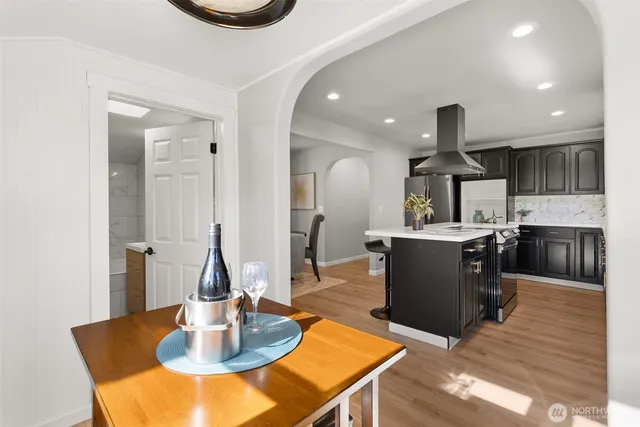 a kitchen with a table chairs and kitchen