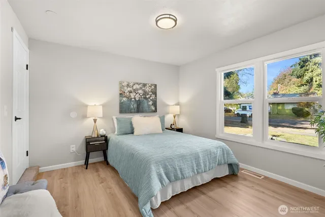 a bedroom with a bed and a window