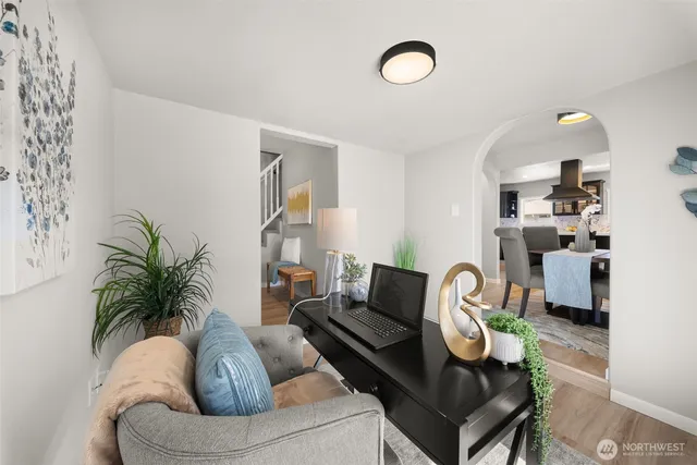 a living room with furniture flowerpot and a window