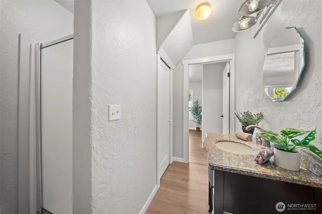 a bathroom with mirror and sink