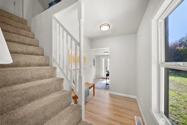 a view of entryway and hall with wooden floor