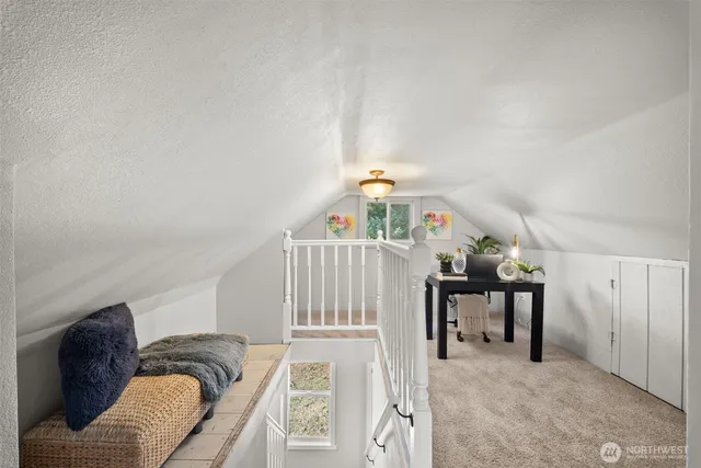 a living room with furniture and stairs