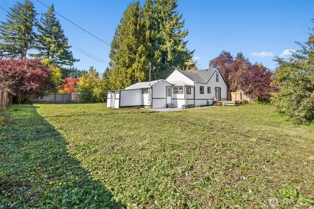 a white house that has a tree in front of it