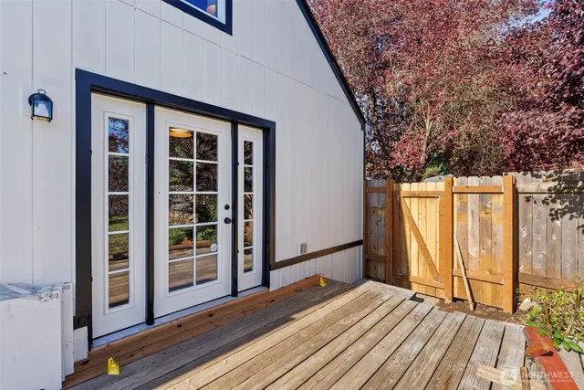 a view of backyard with wooden floor and fence