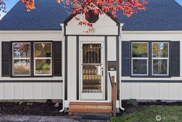 a view of a brick house with large windows