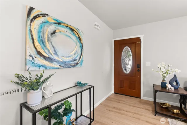 a view of a hallway with entryway wooden floor and a dining room
