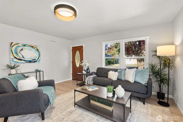 a living room with furniture a rug and a window