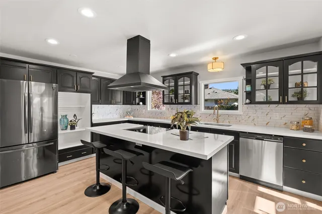 a kitchen with a sink stainless steel appliances and cabinets