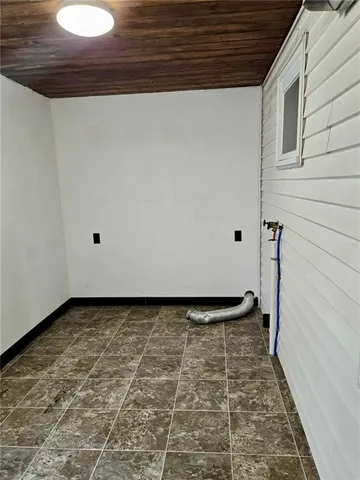 a view of a utility room with a brick wall