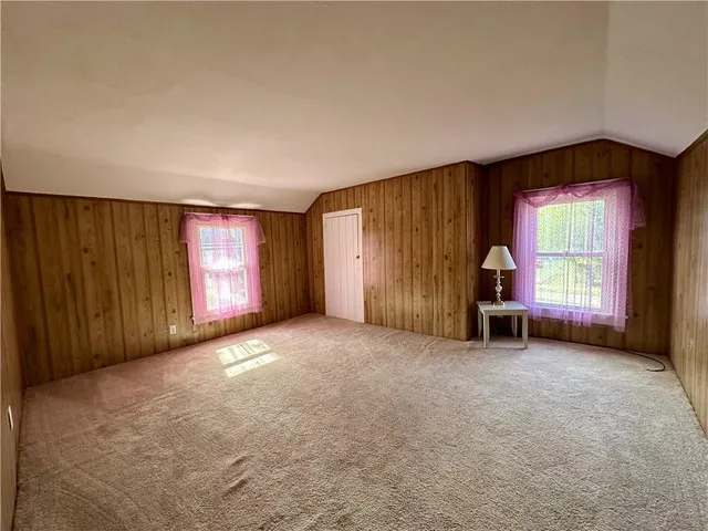 an empty room with windows and closet