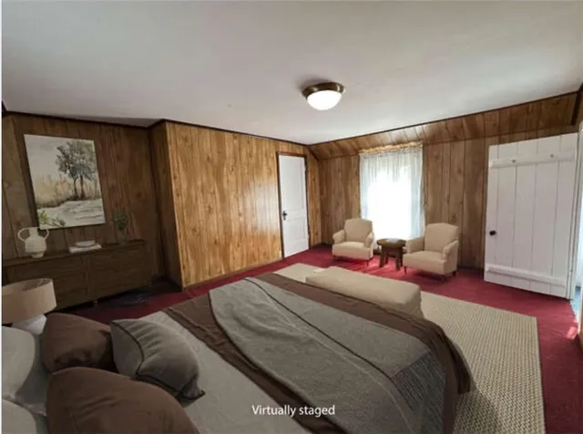 a spacious bedroom with a bed couch and window
