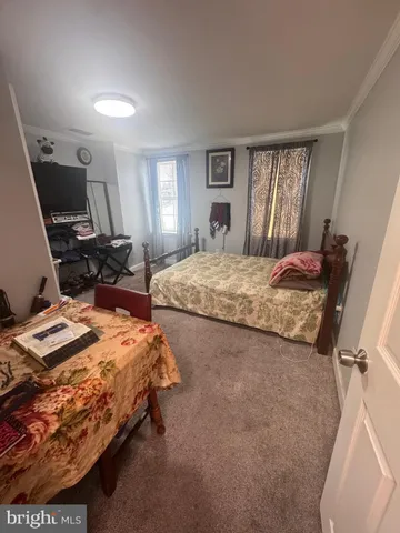 a bedroom with bed and window