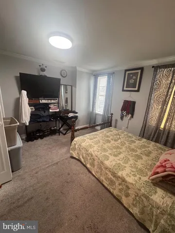 a bedroom with a bed and a television