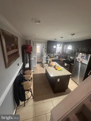 a living room with couches and a dining table with projector