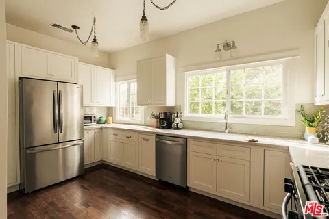 a kitchen with a stove a sink and a refrigerator