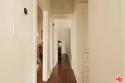 a bedroom with a bed and a mirror