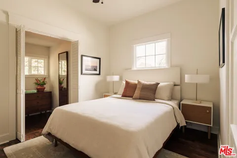 a bedroom with a bed and a large mirror