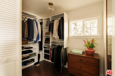 a view of a hallway with wooden shelves