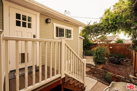 a view of a chairs and table in backyard