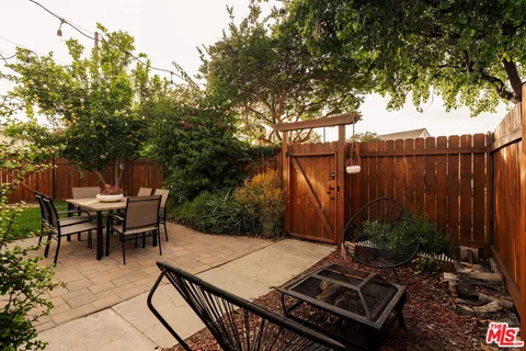 a backyard of a house with table and chairs