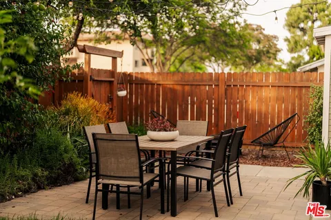 a backyard of a house with table and chairs