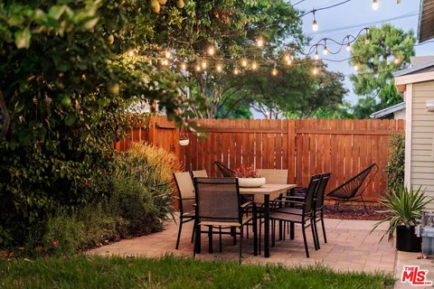 a patio with a yard table and chairs