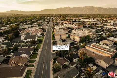 an aerial view of residential houses with city view