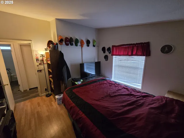 a bedroom with a bed and a desk